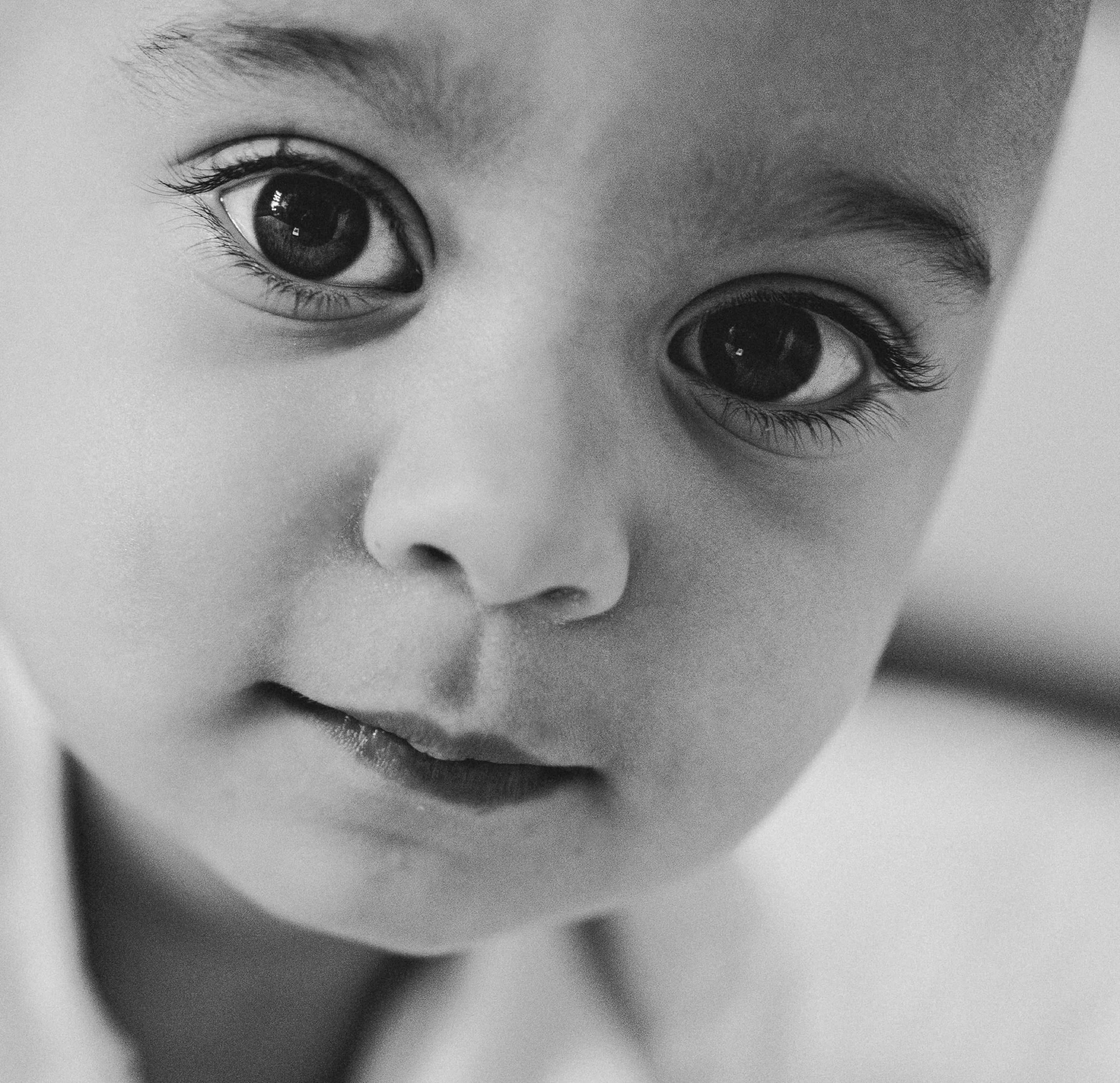 Black and white close up portrait of a baby