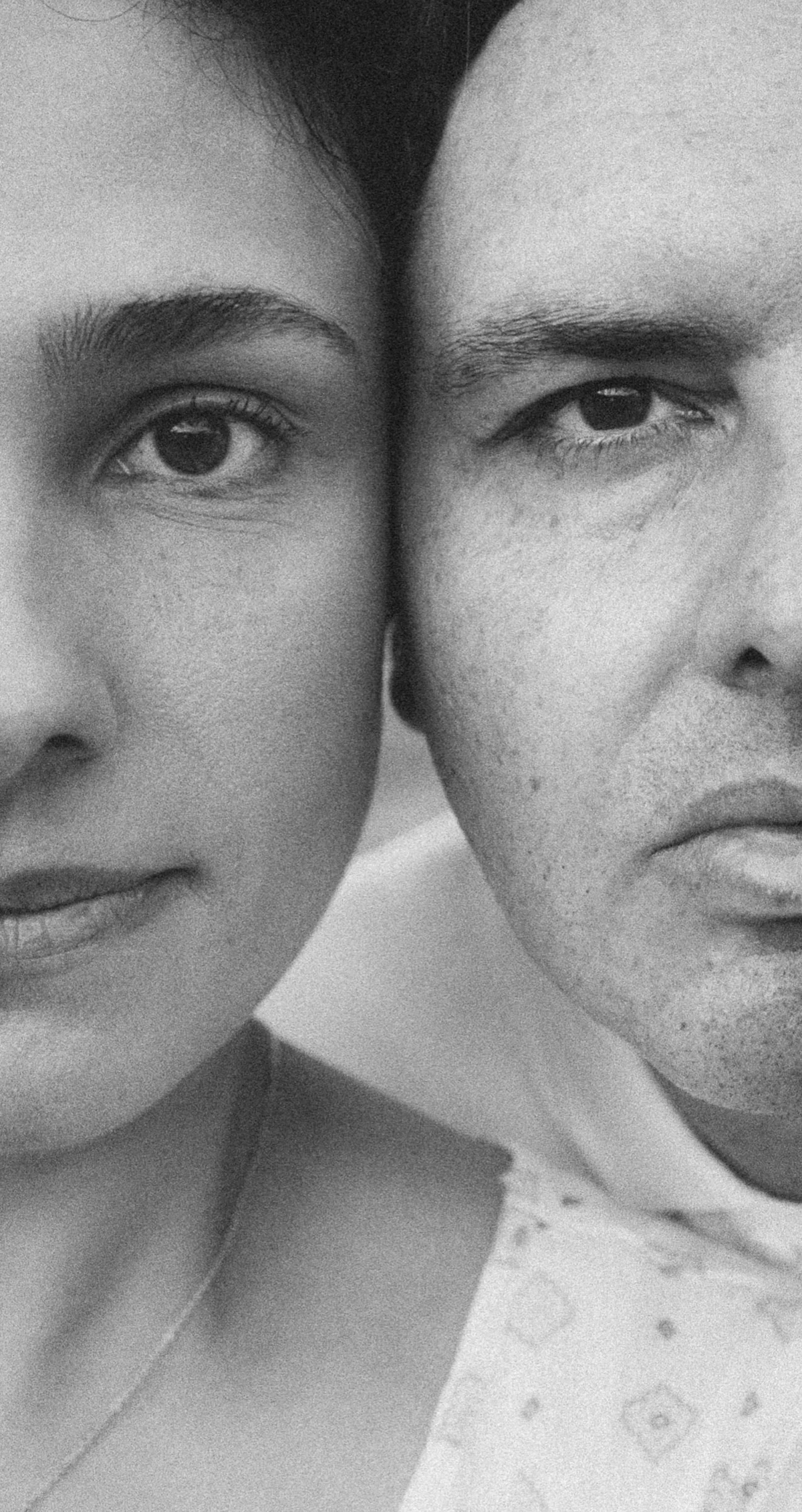 Black and white close up portrait of a couple, faces side by side